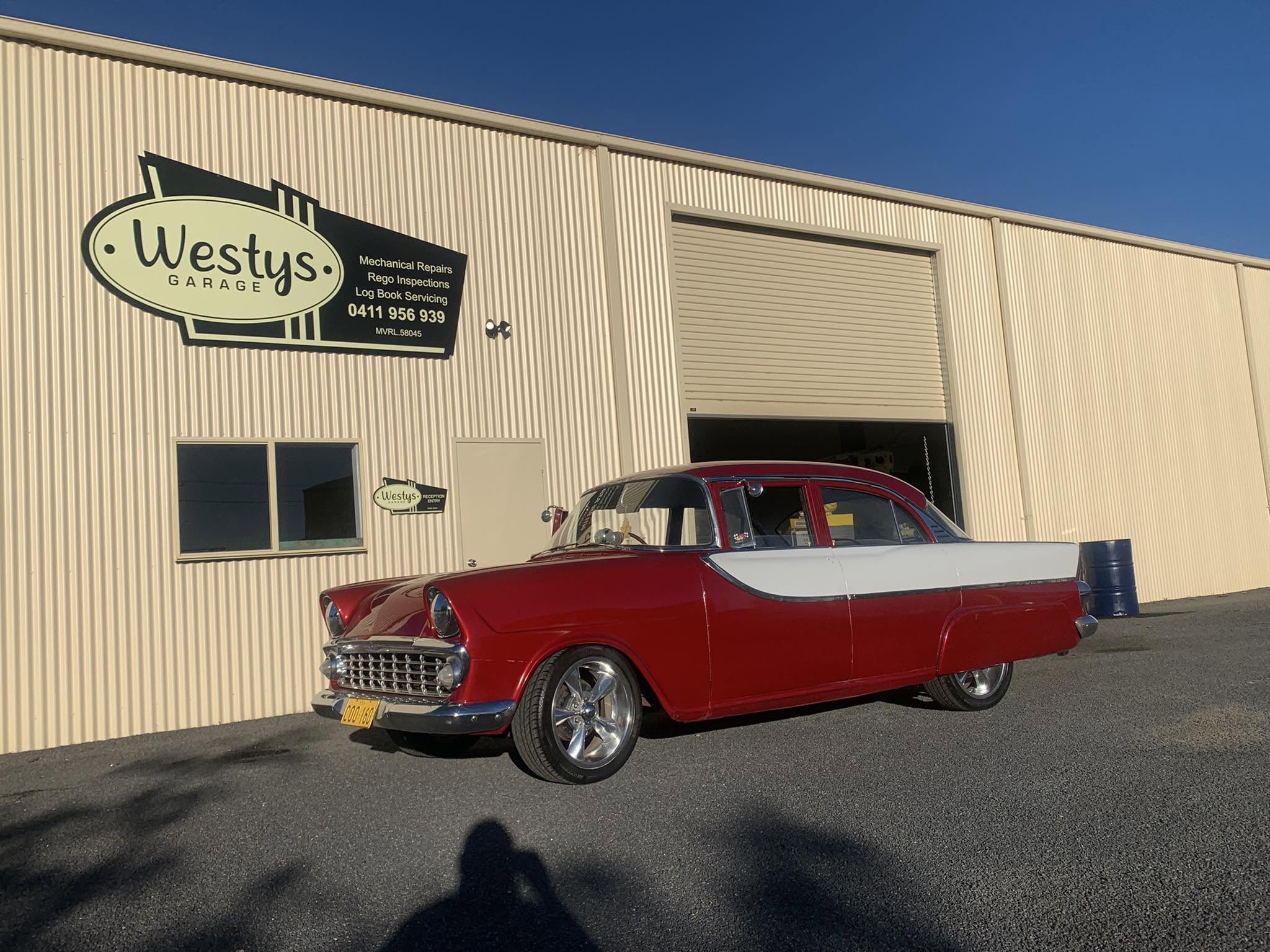 The Westy’s Garage workshop on Kollas Drive, Cowra, with a classic Holden parked out the front