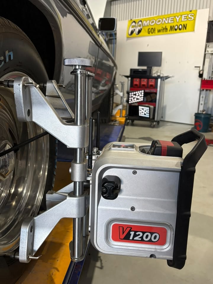 Alignment head clamped to a wheel inside the Westy’s Garage workshop