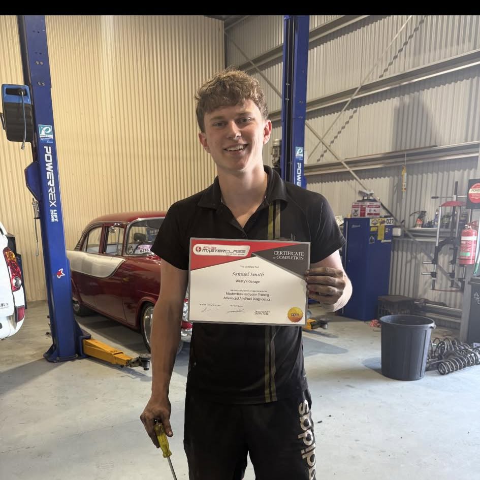 Samuel Smith at Westy’s Garage holding his Auto-Tech Masterclass certificate